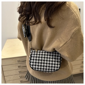 Detail of houndstooth crossbody bag set with wide strap and round coin purse accessory