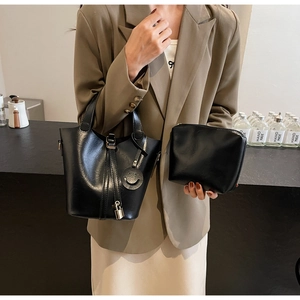 Détail de l'ensemble sac seau noir en similicuir avec petite pochette et charm sourire