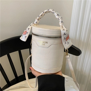White crocodile pattern cylinder handbag with scarf wrapped handle and gold hardware