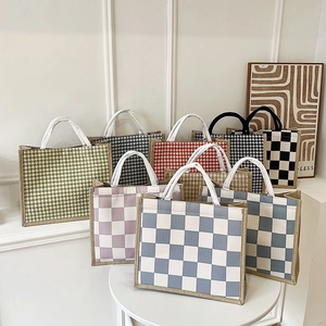 Detail of colorful canvas tote bags showing textured houndstooth and checkered patterns