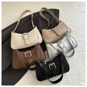 Flat lay view of five vintage crescent shoulder bags in white khaki silver coffee and black