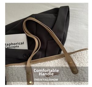 Detail of plush faux shearling tote with brown leather handles and gold metal rivets