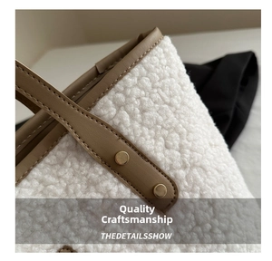 Detail of white sherpa tote bag with brown leather handle and gold rivet hardware
