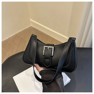 Detail view of the elegant black matte leather bag with a stylish silver square buckle