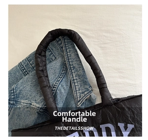 Detail of black puffer tote bag with quilted padding and purple TEDDY lettering