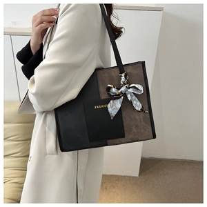 Detail of color-block tote bag with FASHION print and silk scarf on strap