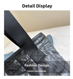Close-up of black quilted tote bag showing reinforced stitching and premium nylon fabric texture