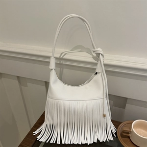 White textured leather shoulder bag featuring stylish tassel trim and knotted strap design
