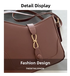 Macro shot of reddish-brown PU leather bag with golden figure-eight buckle detail