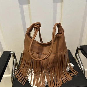 Chic caramel brown tassel shoulder bag in lychee pattern leather with boho knot handle