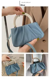 Blue cloud pouch bag detail showing the large pearl handle and pleated faux leather