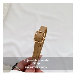 Detail of brown leather adjustable shoulder strap with golden metal square buckle