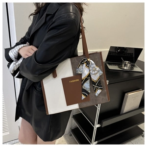 Detail of color-block tote bag with FASHION pocket and silk scarf on the handle