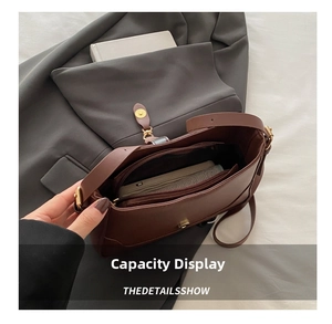 Detail view of the brown leather shoulder bag interior with spacious compartments