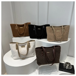 Detail view of plush faux shearling tote bags in five colors with slim leather handles