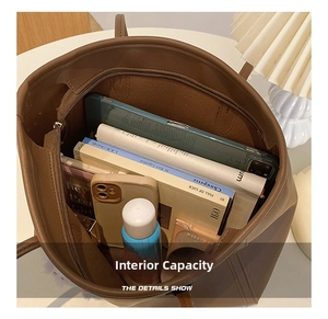 Detailed interior view showing large capacity and internal pockets of the brown tote bag