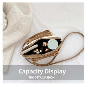 Internal view of crossbody shell bag showing capacity for phone and cosmetics