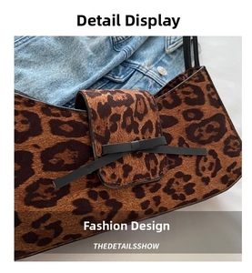 Close-up of leopard print baguette bag with a delicate black bow and velvet texture