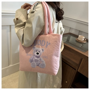 Detailed back view of pink quilted tote bag with cute purple teddy bear print