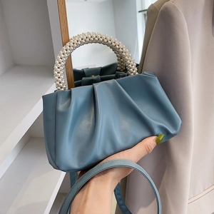 Blue pleated cloud bag with elegant pearl handle and crossbody strap in French style