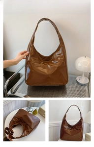 Detail of brown hobo bag showing high-gloss oil wax finish and minimalist leather texture