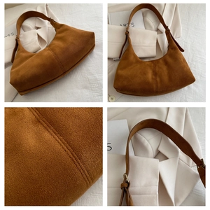 Detail of brown suede shoulder bag showing double stitching and adjustable strap texture