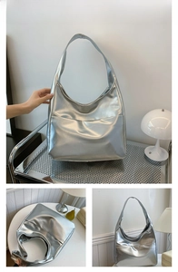 Macro detail of silver large capacity tote bag showing metallic texture and front pocket
