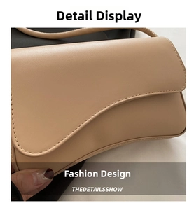 Detail view of the wave-shaped flap and smooth faux leather texture on the beige bag