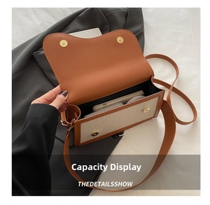 Top view showing the spacious interior of a brown leather and beige canvas crossbody bag