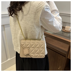 Chic beige quilted small square bag with golden chain strap shown in lifestyle daily wear