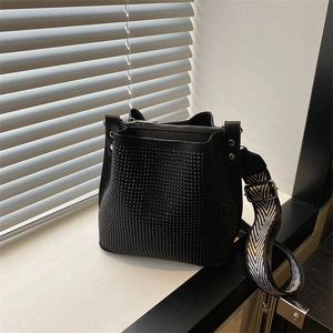 Modern black rhinestone bucket bag with geometric black and white wide woven strap