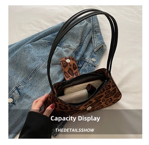 Top view of leopard print baguette bag showing interior capacity for phone and lipstick