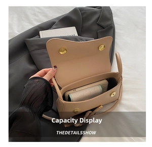 Detail showing the internal storage capacity of the beige square crossbody bag with wallet