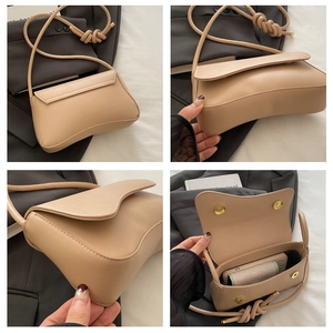 Detail view of beige shoulder bag showing wave flap, knot strap and magnetic closure