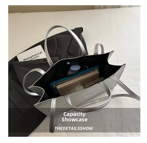 Spacious silver tote bag interior with multiple compartments for books and tablets