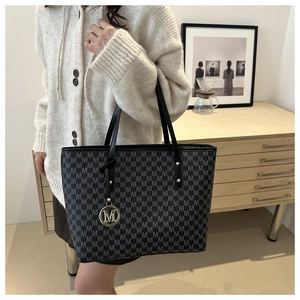 Classic grey monogram tote bag with gold M-pendant and leather straps for commute