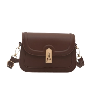 Vintage dark brown crossbody bag with U-shaped quilting and gold metal clasp on white background