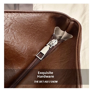 Detailed close-up of premium silver hardware and textured brown leather on a tote bag