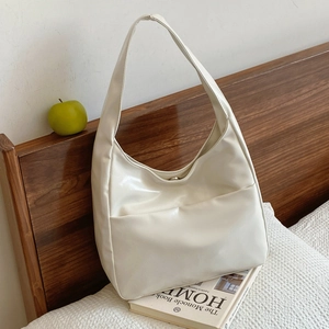 Minimalist cream white hobo shoulder bag with large front pocket and soft leather finish