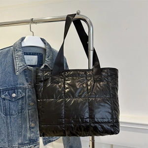 Black quilted puffer tote bag with large capacity for daily commuting and shoulder wear