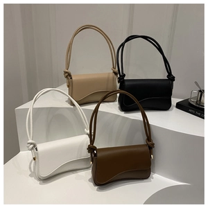 Minimalist matte leather baguette bags in four colors displayed on geometric stands