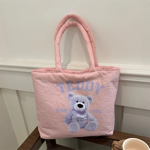 Pink quilted puffer tote bag featuring purple teddy bear print and baby girl text
