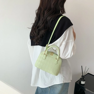 Chic mint green woven shell crossbody bag with top handle and gold zipper hardware