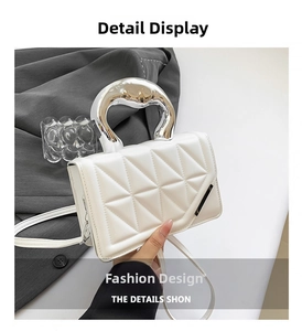 Detailed view of white quilted mini handbag with futuristic silver metal handle