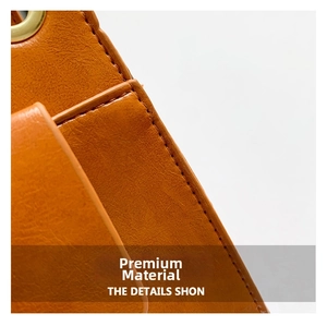 Macro view of brown-orange leather texture and premium gold metal ring buckle detail