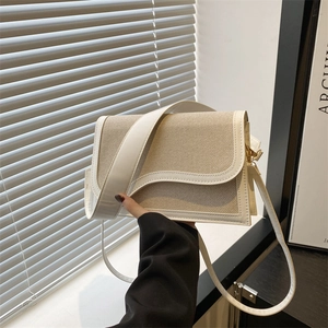 Chic beige canvas and white faux leather crossbody bag with gold hardware detail