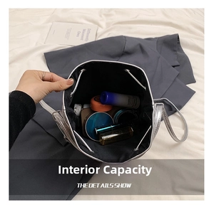 Internal capacity of silver bucket bag showing cosmetics and daily essentials