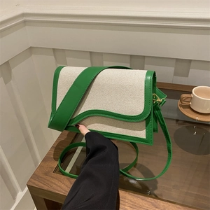 Retro canvas shoulder bag in cream and green leather trim with wavy flap design