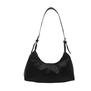 Minimalist black crescent shoulder bag with adjustable strap and zipper closure
