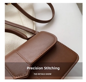 Close-up of precise stitching and premium leather texture on a brown vintage crossbody bag